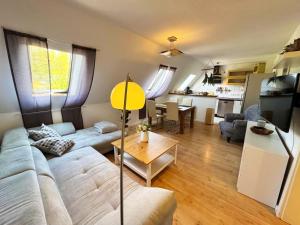 a living room with a couch and a table at Ferienwohnung am Haff in Ueckermünde