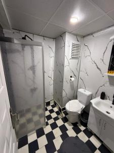 a bathroom with a shower and a toilet and a sink at Nigrum Hotel Nevsehir Cappadocia in Nevşehir