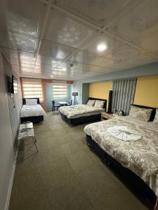 a large room with three beds in it at Nigrum Hotel Nevsehir Cappadocia in Nevşehir