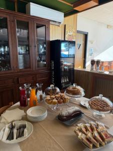 a table with plates of food and a refrigerator at hotel cri cri - fronte spiaggia in Silvi Marina