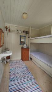 a room with two bunk beds and a sink at Haus Hav in Ronneby