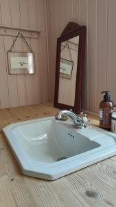 a bathroom sink with a mirror on a counter at Haus Hav in Ronneby