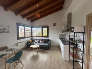 a living room with a couch and a table at Apartamentos El Respigu in Cangas de Onís
