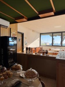 a kitchen with a table with two trays of food at hotel cri cri - fronte spiaggia in Silvi Marina