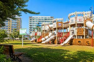 a playground with a slide in a park at Caesar Resort & Spa Collection Studios Pools & Long Beach in Iskele