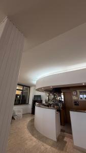 a large kitchen with a counter in a room at hotel cri cri - fronte spiaggia in Silvi Marina