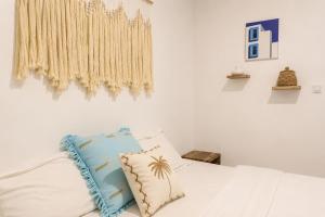 a bedroom with a bed with a pillow on it at Elia's House renovated in Canggu