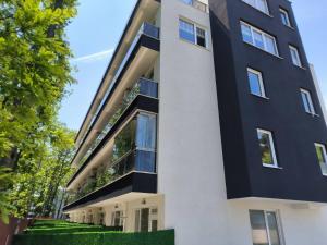 an apartment building with a black and white facade at Studio ONE in Kiten