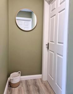 a hallway with a mirror and a door at Waterfall Cottage in Killybegs +17 photos