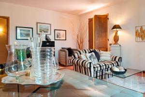 a living room with a glass table and a couch at Apartment Panzano in Panzano