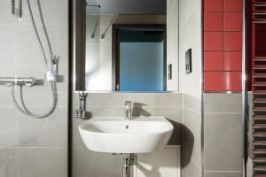 a bathroom with a sink and a shower at MEININGER Hotel Edinburgh Haymarket in Edinburgh +13 photos