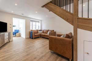 a living room with a couch and a television at Stretton Lower hall in Malpas