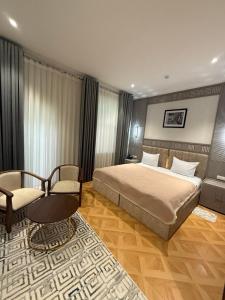 a bedroom with a bed and a couch and a chair at Karvon Plaza Hotel in Samarkand +39 photos
