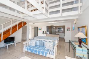 a bedroom with a bed and a living room at Seabreeze Bungalow in Langebaan