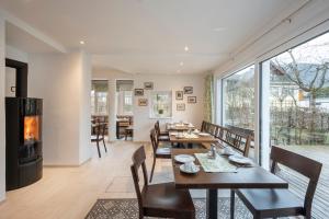 a dining room with tables and chairs and a fireplace at Hotel Garni Carl Michael in Strobl +23 photos