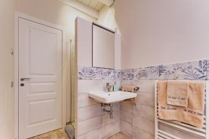 a white bathroom with a sink and a mirror at Corte Lavarini in Fumane +117 photos