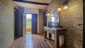 a hallway with a stone wall and a fireplace at AT El Cordel in Nogales