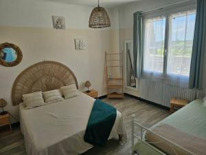 a bedroom with a bed and a window at Partie de villa in Velleron