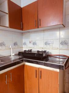 a kitchen with a sink and a counter top at 1BDM Aptmt Free Wifi,TV, NETFLIX,FRIDGE,KITCHEN-busy area in Dar es Salaam