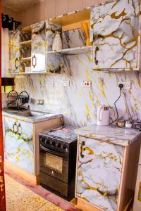 a kitchen with a stove and a counter top at Makenahluxuries Embu Paradise Apartment near Java Gakwegori in Kangaru