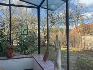 a statue in a room with a window at Haus Prälank in Neustrelitz