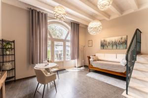 a bedroom with a bed and a table and a window at Corte Lavarini in Fumane