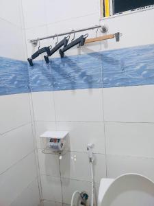 a bathroom with a toilet and pipes on the wall at 1BDM Aptmt Free Wifi,TV, NETFLIX,FRIDGE,KITCHEN-busy area in Dar es Salaam