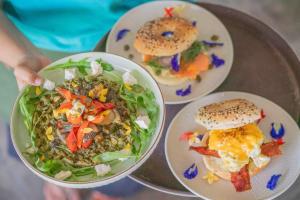 a table with three plates of food on it at Bale Sampan Boutique Bungalows in Gili Trawangan