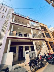 a building with motorcycles parked in front of it at Wee Homes in Bangalore