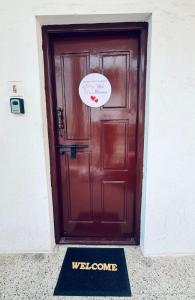 a door with a welcome sign in front of it at Wee Homes in Bangalore