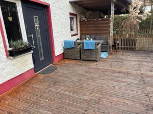 a patio with a table and chairs next to a door at Waldbaden in Fürthen