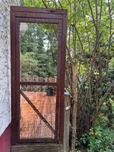 an open door to a patio with a fence at Waldbaden in Fürthen