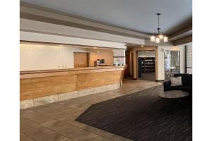 a lobby with a reception desk and a waiting room at Studio 6 Suites Butte MT I-90 I-15 in Butte