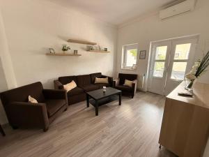 a living room with a couch and a table at Balaton Bloom 24 in Siófok