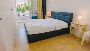 a bedroom with a bed and a table and a window at Residence Relais du Lac Village & Elite in Desenzano del Garda +277 photos