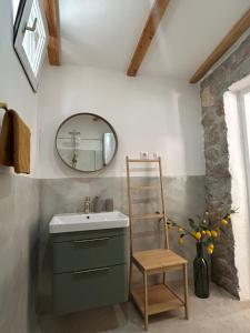 a bathroom with a sink and a ladder and a mirror at Stone house Vert in Sveti Jakov +17 photos