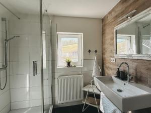 a bathroom with a sink and a shower at Feriendorf Falkenegg in Lennestadt +166 photos