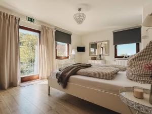 a bedroom with a large bed and a large window at Feriendorf Falkenegg in Lennestadt