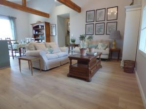 a living room with couches and a table at Luxury Gites de Chateau Mirabel - Latour - with saltwater swimming pool and AC in Puylaurens +71 photos