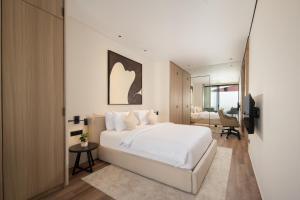a bedroom with a large white bed and a desk at Echo Beach Villas 6 in Canggu +72 photos