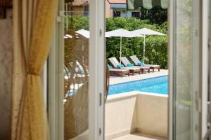 a view of a pool through a sliding glass door at Villa MontAnja in Herceg-Novi +33 photos
