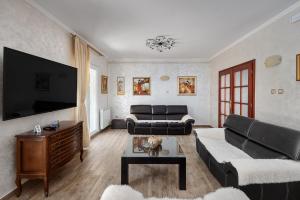 a living room with a couch and a tv at Villa MontAnja in Herceg-Novi