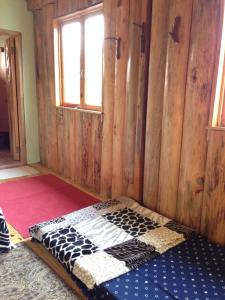 
A bed or beds in a room at Agape Log Cabin And Restaurant
