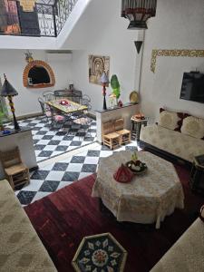 a living room with a couch and a table at Riad Anbar in Marrakesh