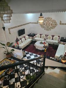 a living room with a couch and a table at Riad Anbar in Marrakesh
