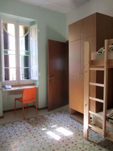 a room with a desk and a bed and a chair at Corner Hostel in Sliema
