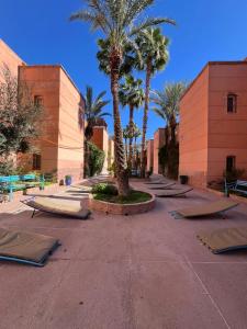 a row of mattresses on a street with palm trees at Riad Anbar in Marrakesh