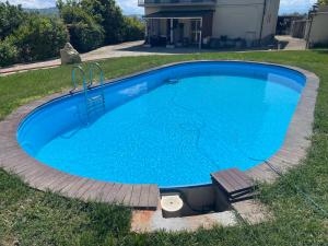 a large blue swimming pool in a yard at CASA VACANZE DA LUCA in SantʼElpidio a Mare