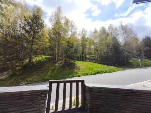 a wooden bench sitting on the side of a road at AC Apartaments Incles in Incles