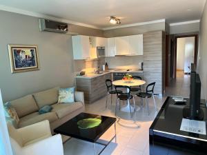 a living room with a couch and a table at Pine Resort by Residence in Strožanac